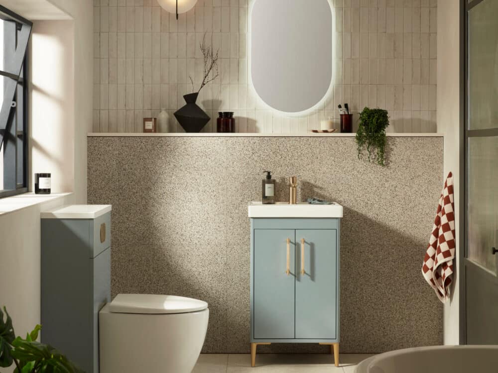 An R2 Paragon 500mm freestanding vanity unit in powder blue with an oval illuminated mirror and a crittall window