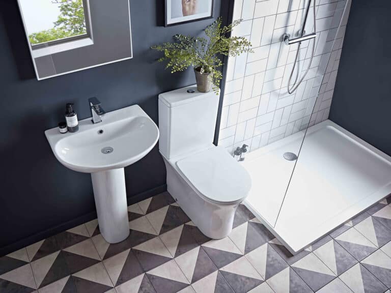 An R2 Radar fully enclosed back-to-wall WC with a matching basin and pedestal on a patterned floor