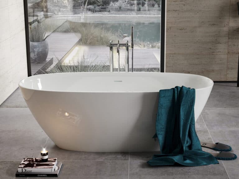 Roca Ariane oval freestanding bath with a floor-standing bath filler beside a glazed garden wall