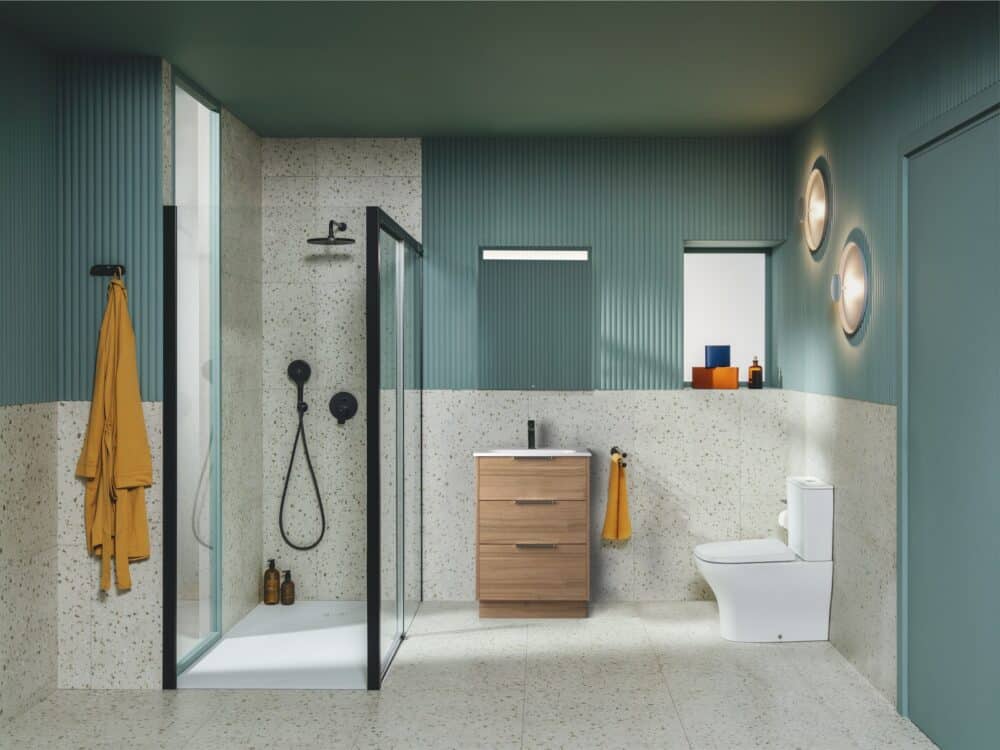 Roca Optica vanity with walnut plinth, toilet and walk-in shower in a green panelled bathroom