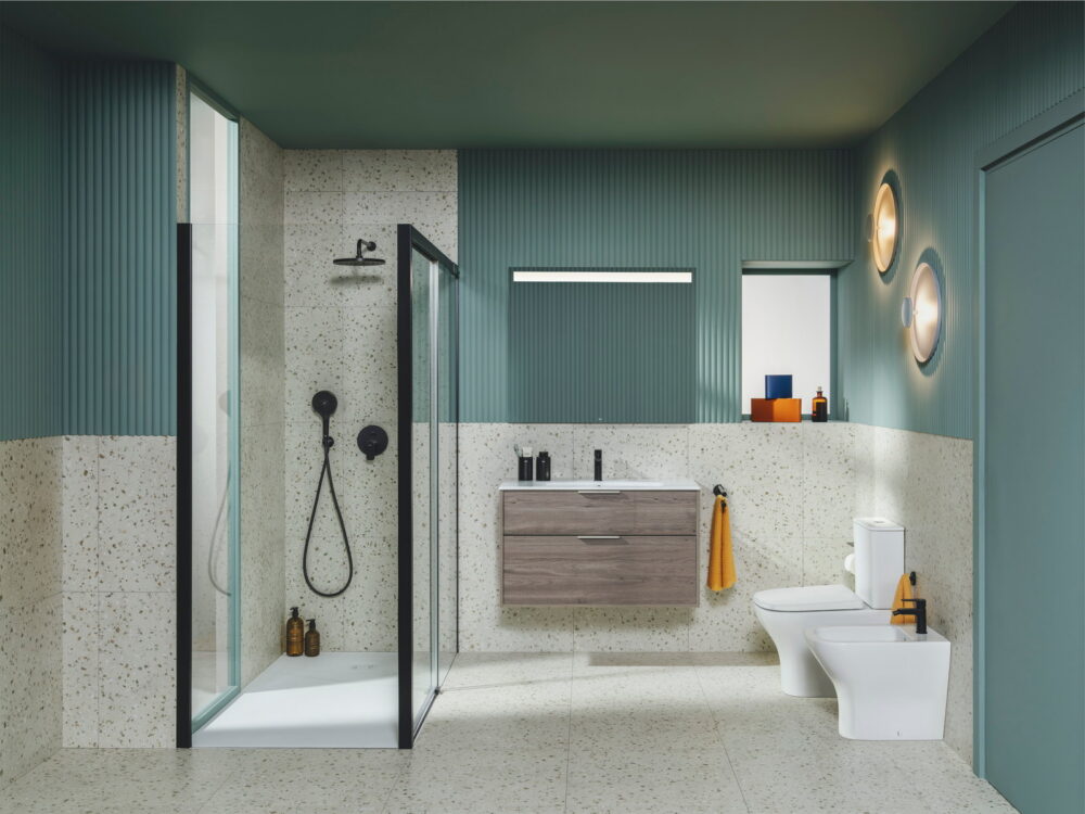 Roca Optica walk-in shower, oak vanity unit and close-coupled WC in a terrazzo and sage green bathroom