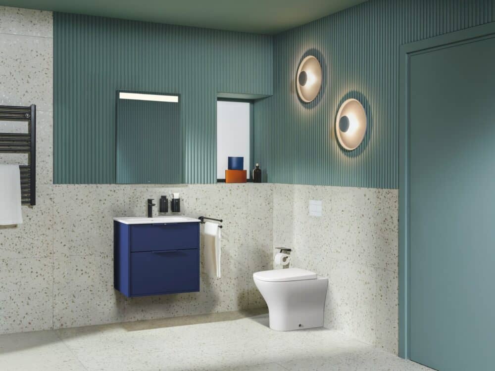 Roca Optica steel blue vanity unit with a back-to-wall toilet and terrazzo wall