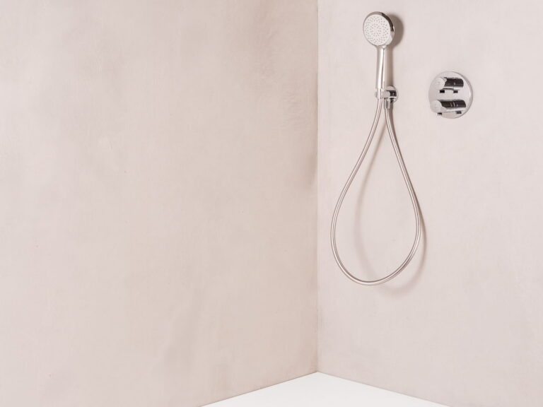 Roca Terran-N level-access shower tray with a flush drain, a chrome handset and a concealed valve in a plaster shower