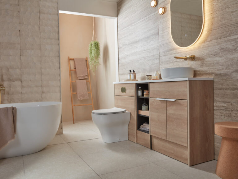 A Roper Rhodes Aruba fitted furniture run in oak with a countertop basin and a back-to-wall WC