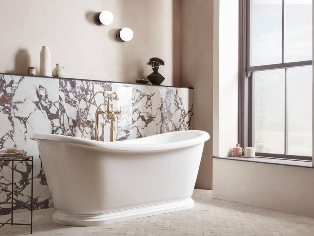 Roper Rhodes Globe wall lights above a roll top bath and a calacatta viola marble surround