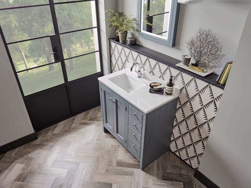 Roper Rhodes Hampton vanity unit in agave on a herringbone floor beside crittall doors