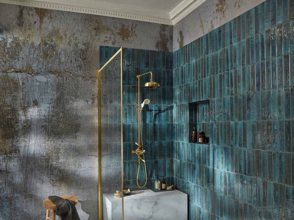 Brushed brass Roper Rhodes Keswick shower against teal metro tiles in a walk-in enclosure