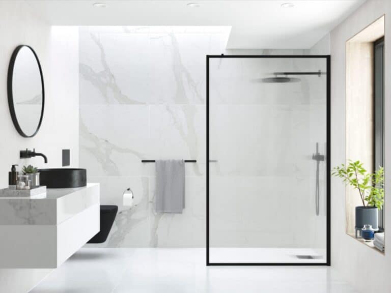 Black-framed fluted glass shower enclosure in a white marble bathroom