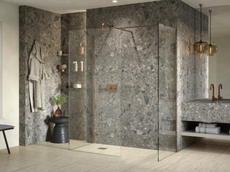 Walk-in shower with bronze-framed glass panels and stone-effect walls