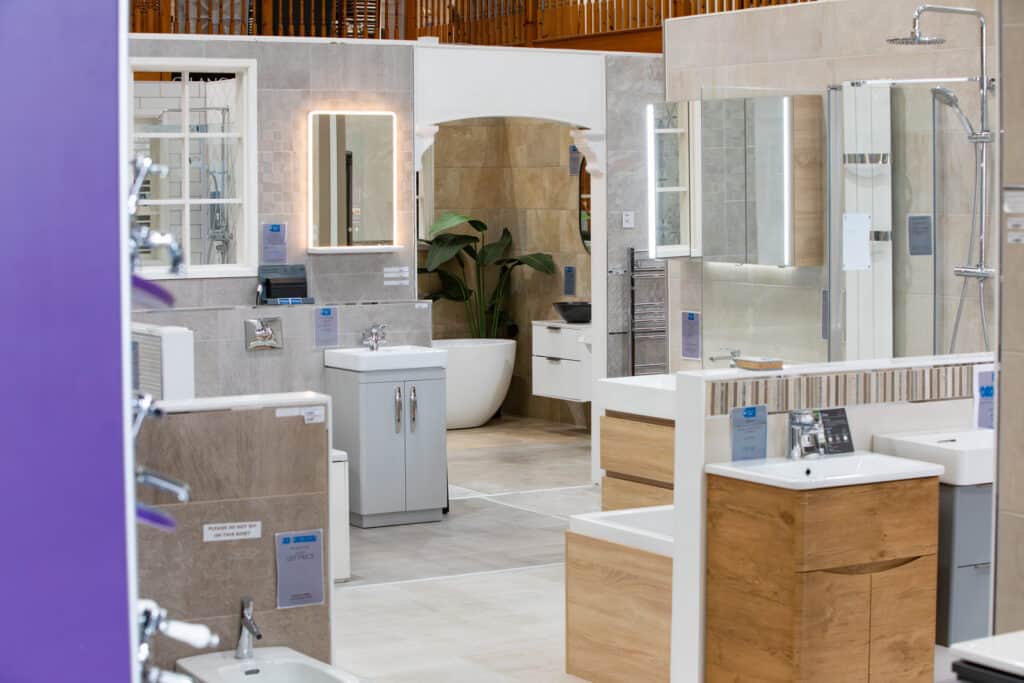 A wide view along the showroom floor, with bathroom displays on both sides