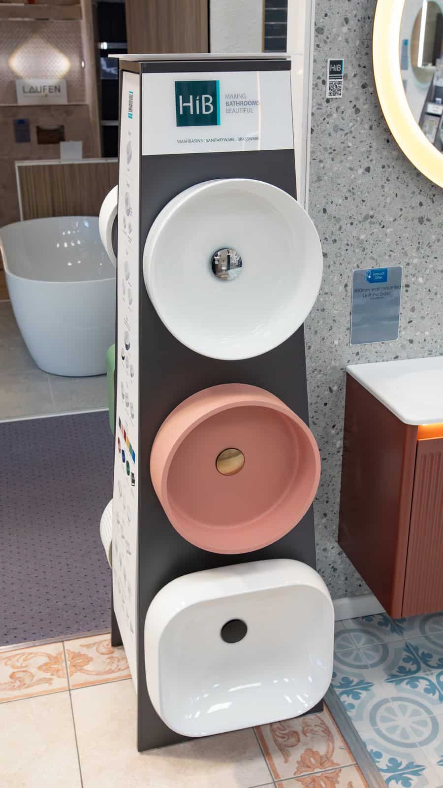 A hib basin display stand showing white and pink countertop basins