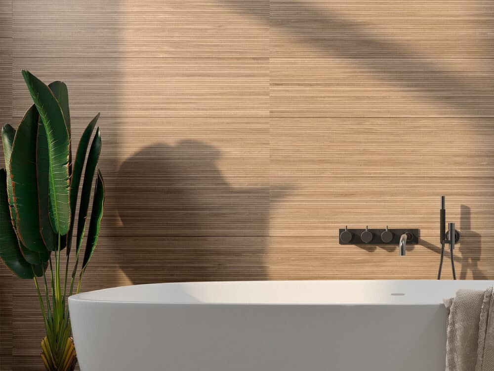 Craven Dunnill Linwood Natural wood-effect ribbed wall tiles behind a freestanding bath