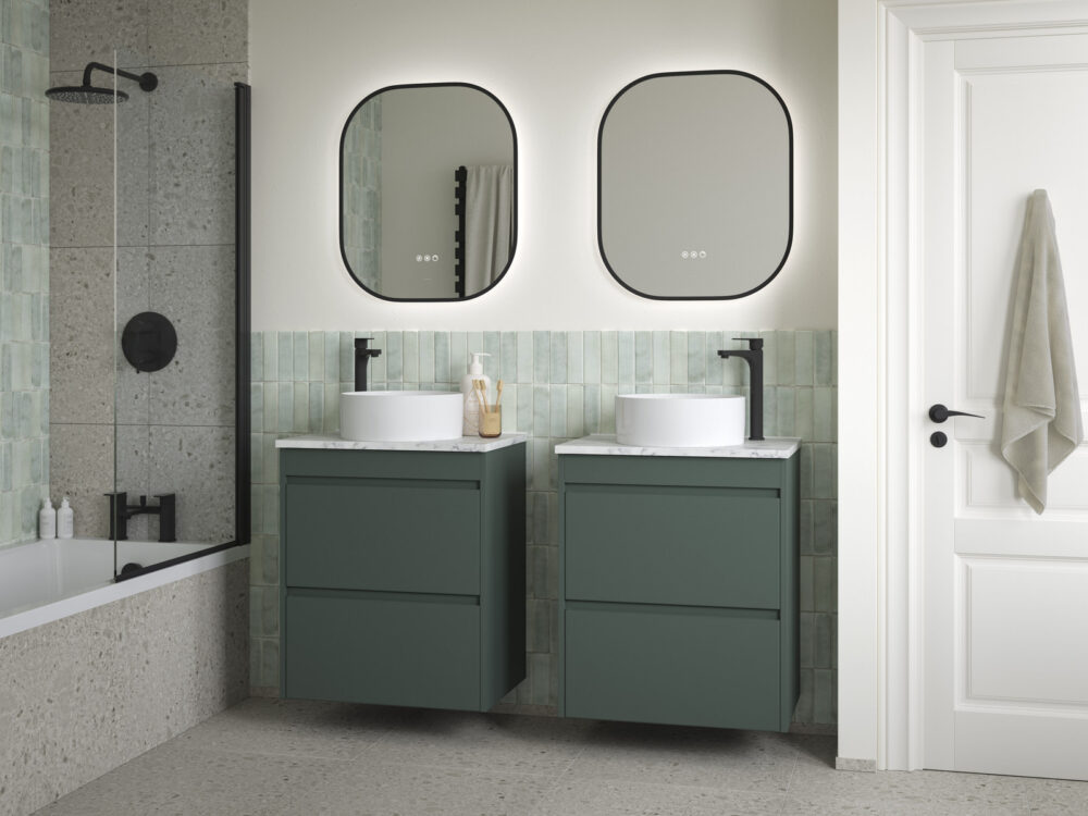 Veldeau Elmore evergreen twin vanity units with countertop basins and matching mirrors beside a bath