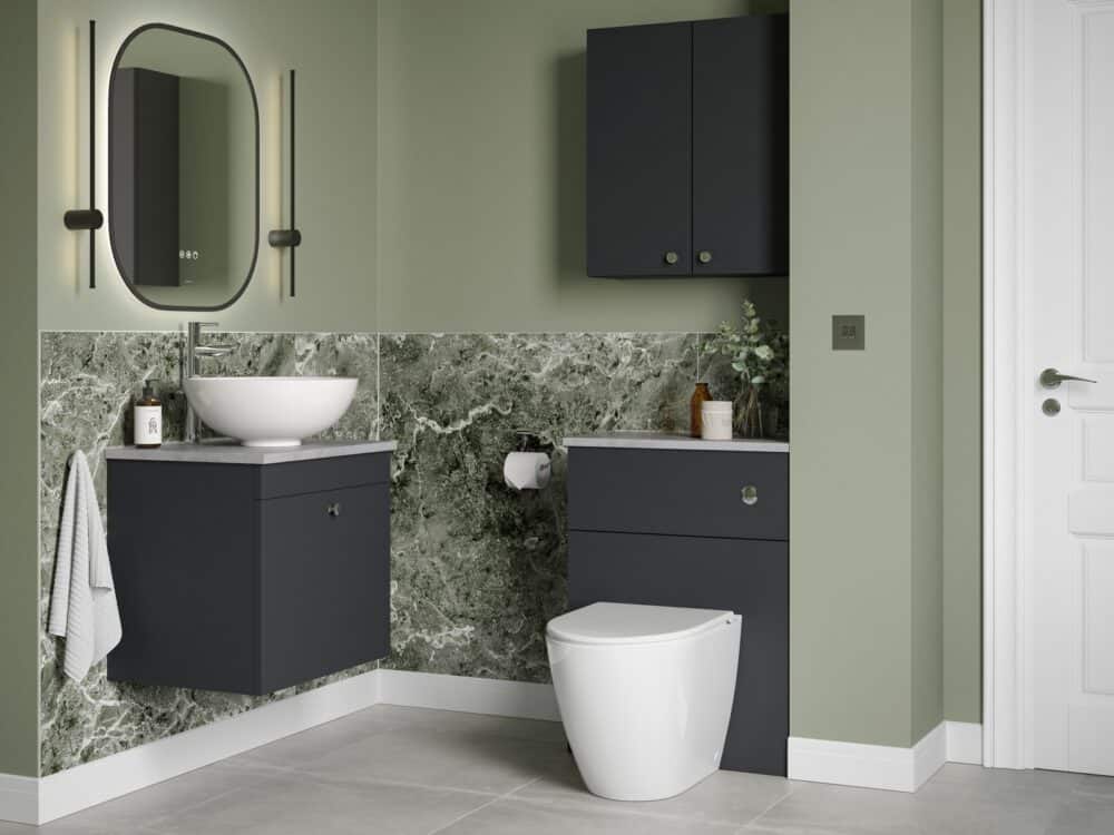 Veldeau Aston matt graphite fitted furniture and toilet against a green marble wall