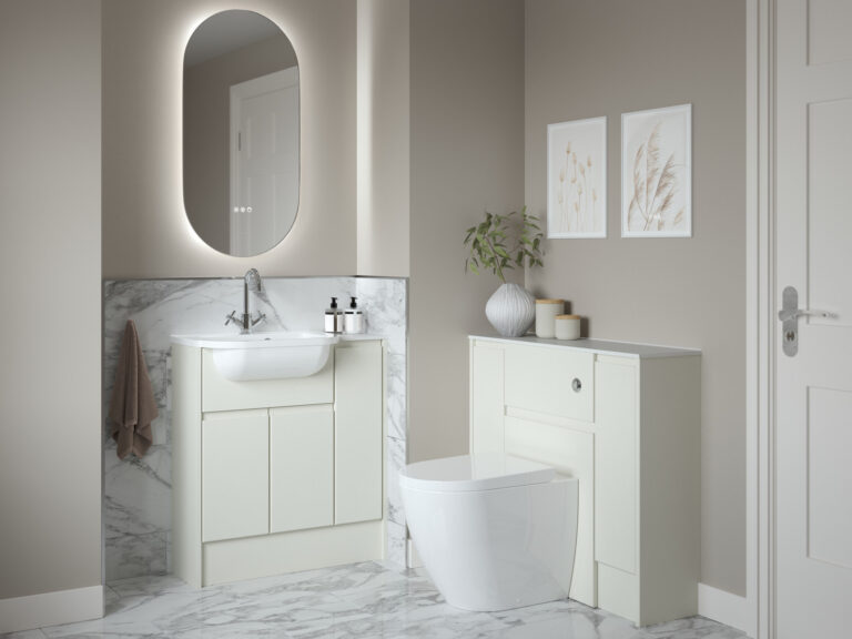 Veldeau oval illuminated mirror with a backlit glow above an Elmore antique white vanity unit and marble wall