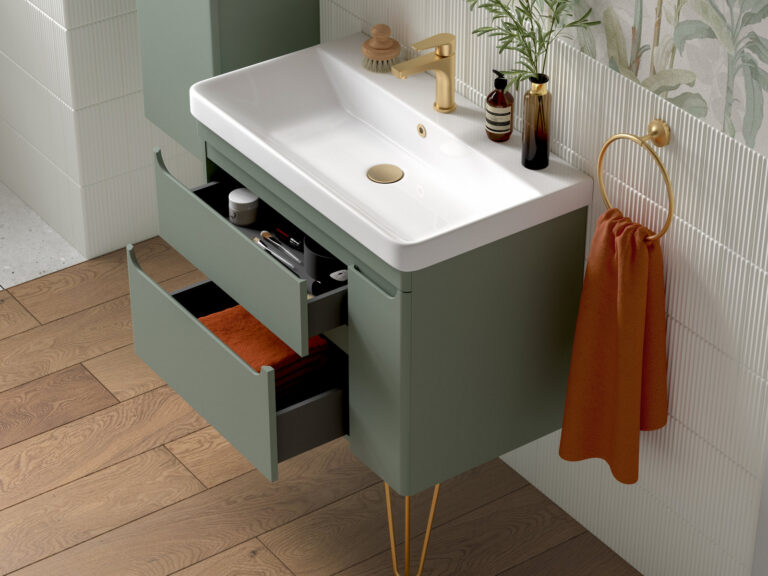 Veldeau Byford willow green wall-hung vanity unit on brass legs with both drawers open and a brushed brass tap