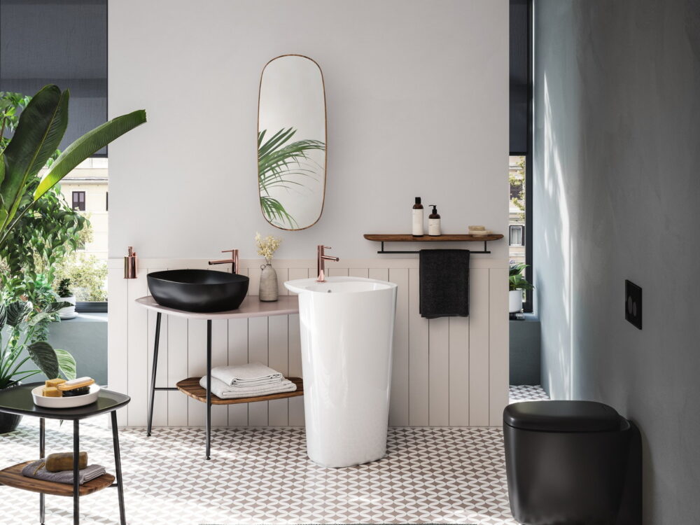 VitrA Plural freestanding pedestal washbasin with a slim mirror and patterned floor tiles