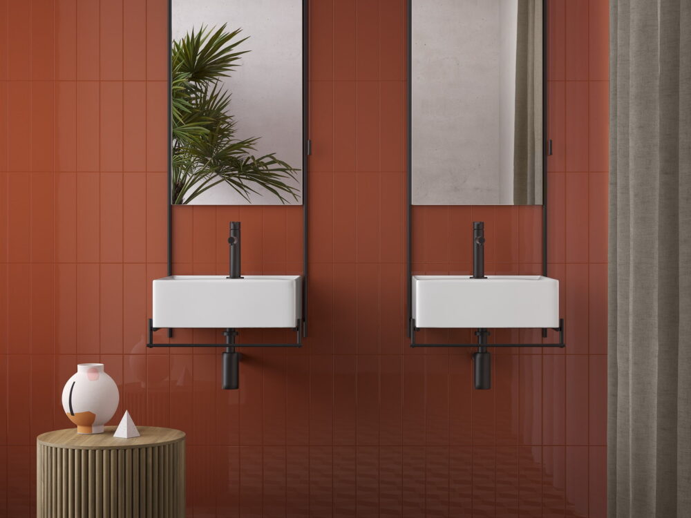 VitrA Equal twin wall-hung washbasins with tall mirrors against a terracotta wall and geometric floor