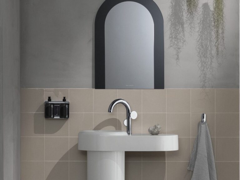Vitra Liquid chrome basin mixer on a pedestal basin against beige tiles