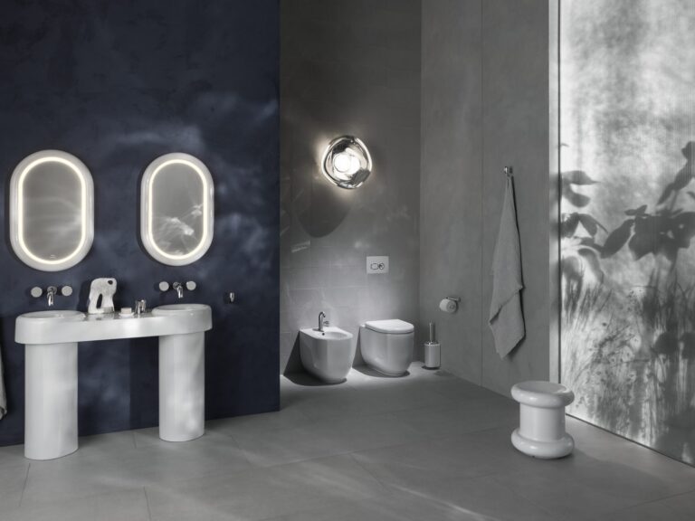 Vitra Liquid double basin, bidet and floor-standing WC in a grey and navy bathroom