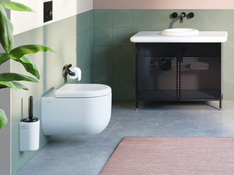 Vitra Liquid toilet brush holder and toilet roll holder beside a wall-hung WC and green tiles
