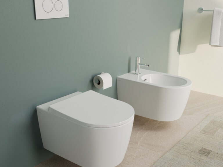 VitrA wall-hung rimless WC and matching bidet against a sage green wall