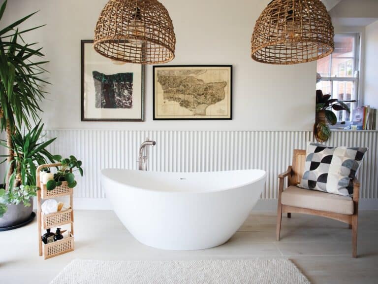 Waters Aurora freestanding bath with a floor-standing tap, rattan pendant lights and trailing plants