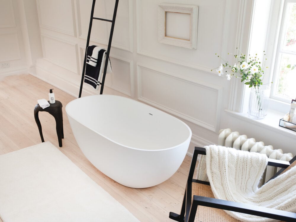 Waters Mist freestanding bath in a white panelled room with a black ladder rail